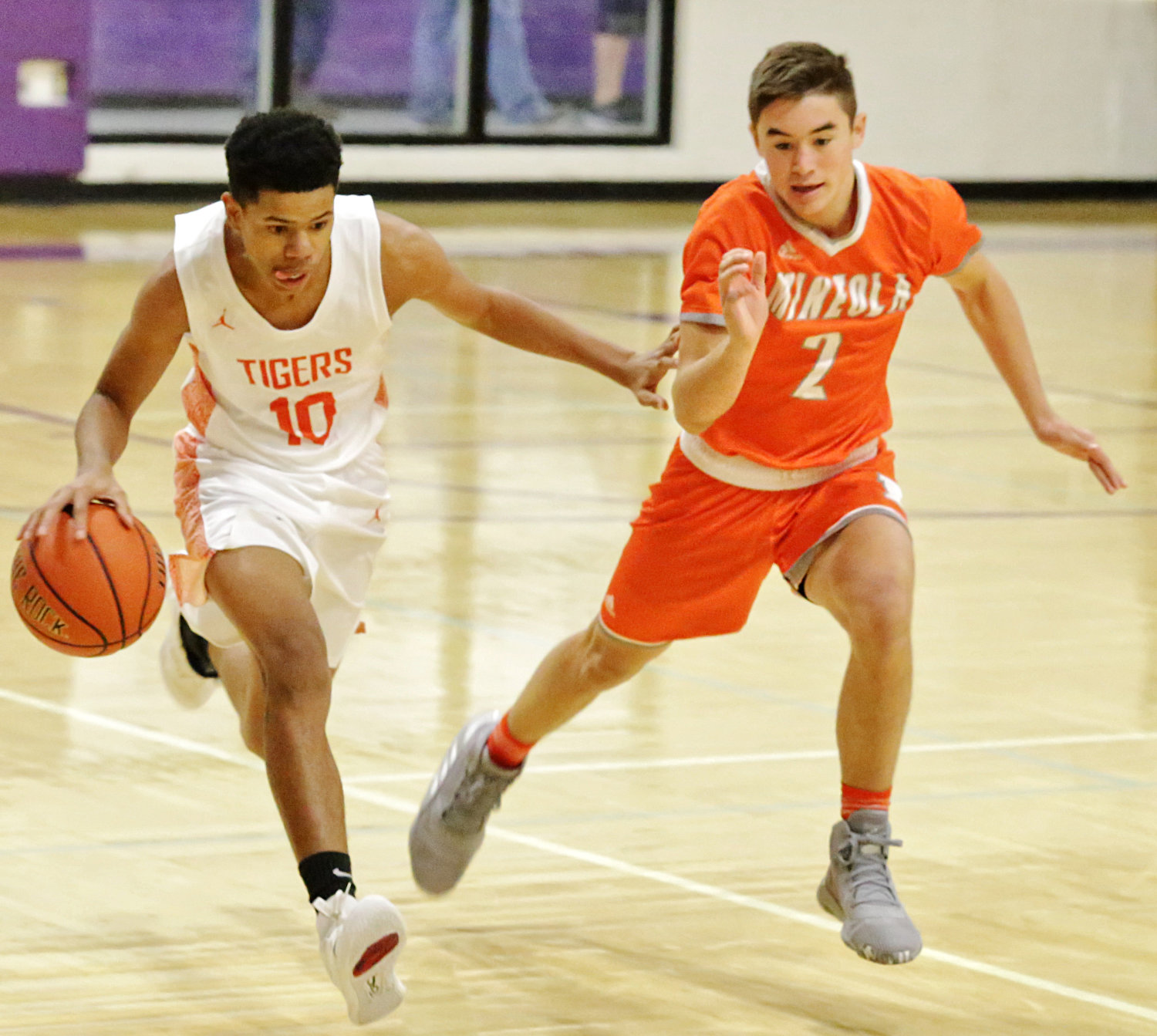 T.J. Moreland, right, of Mineola presses the ball in tourney play against Commerce.
